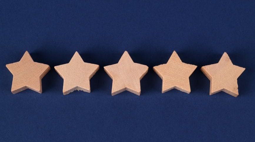 five wooden stars on blue background